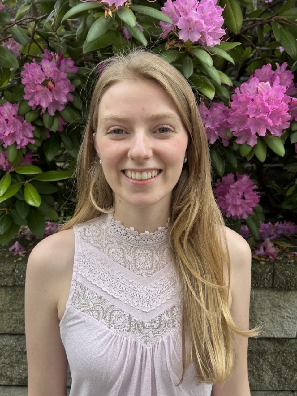 A photo of a blonde woman smiling.